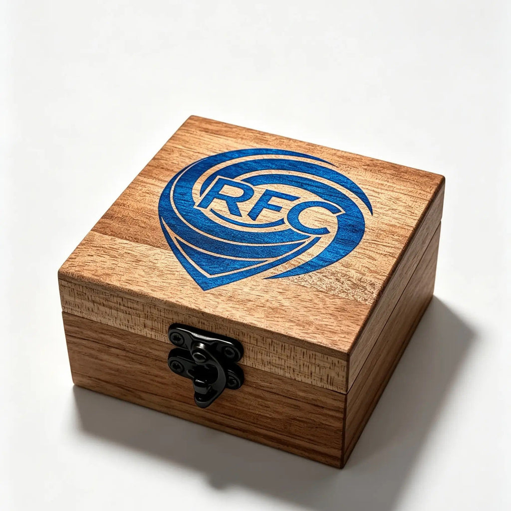 A square wooden keepsake box with a black metal latch, featuring a blue 'RFC' logo on the lid, set against a clean white background.