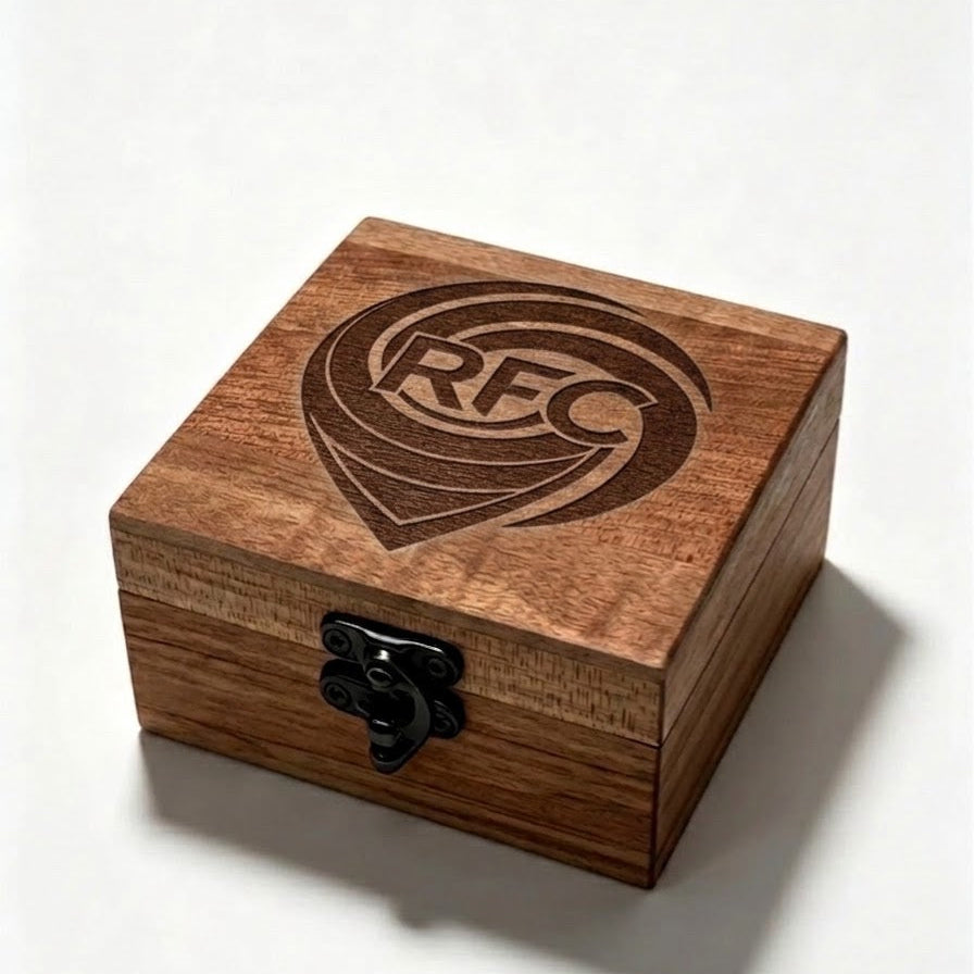 A square wooden keepsake box with a black metal latch on the front and a brown RFC logo on the lid, set against a plain white background.